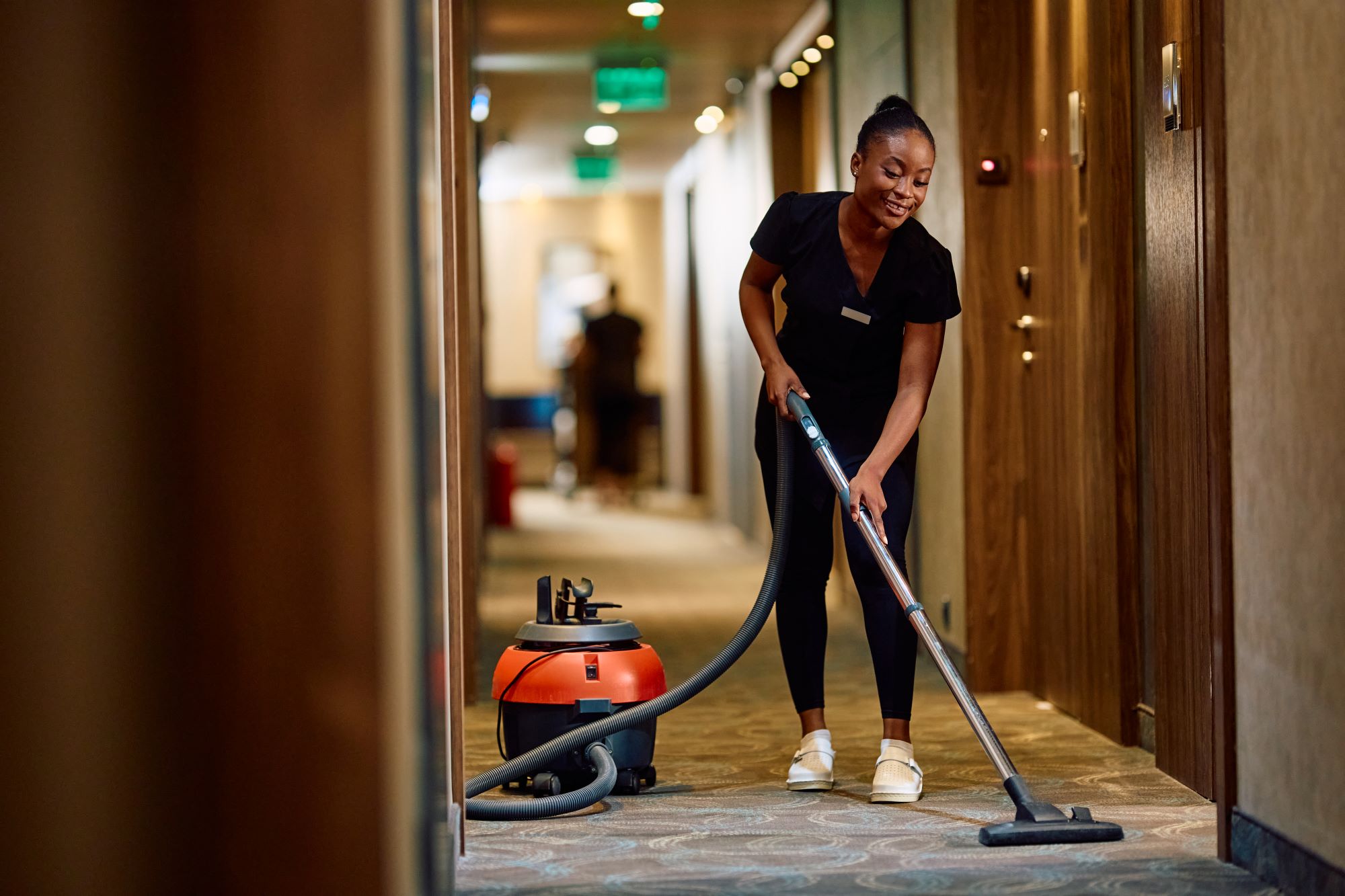 Young black maid vacuuming hallway while working i 2024 12 13 18 32 59 utc